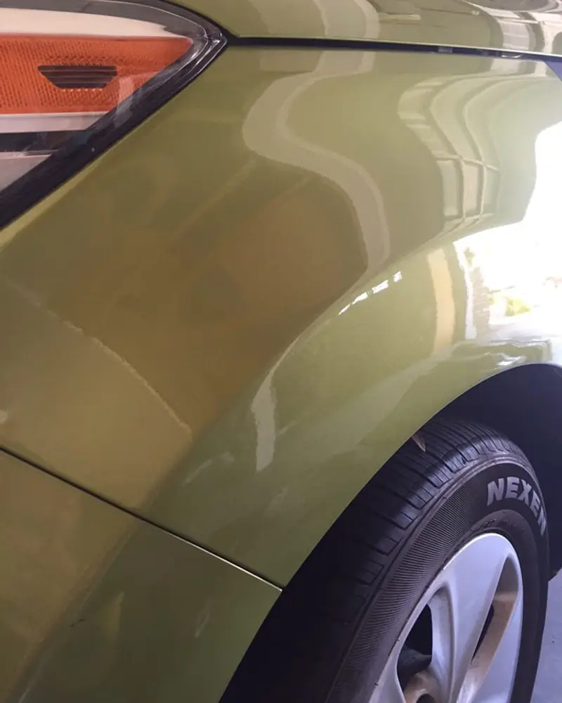 After: Dent above the rear wheel